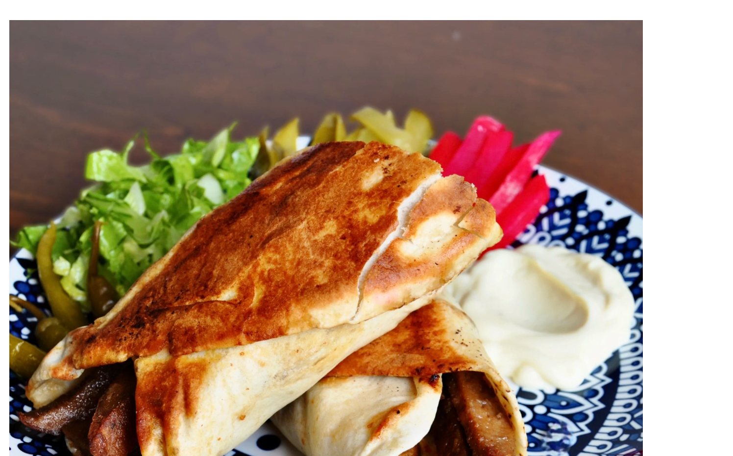 Chicken shawarma wrap with pickles and garlic sauce